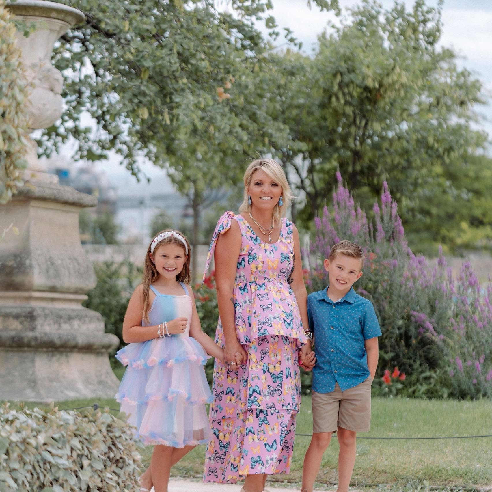 Sam with her two kids in a garden